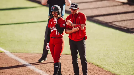 Hunter Veach and Lauren Allred at first base after Lauren did something to get on first base in a softball game