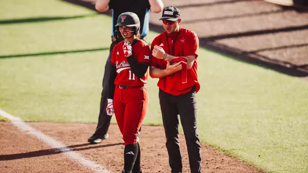 Hunter Veach and Lauren Allred at first base after Lauren did something to get on first base in a softball game