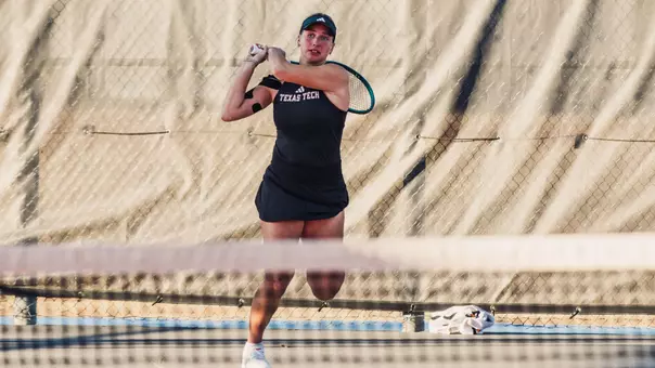 Mariia Hlahola following through on a backhand.