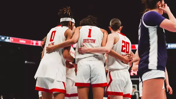 The Lady Raiders huddle up during the game.