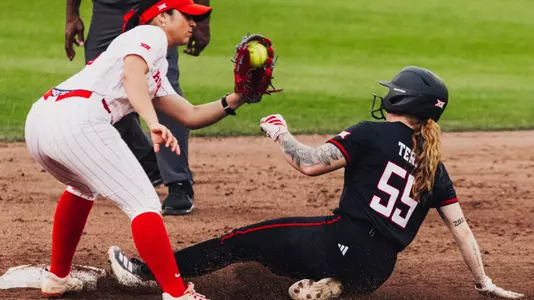 Kaitlyn terry sliding into second base as she steals a bag against Houston