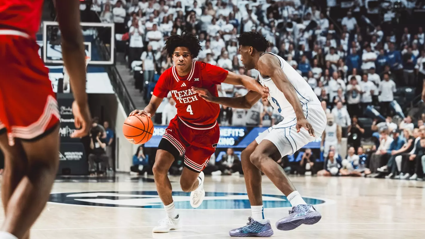 Christian Anderson drives past a BYU defender for a basket.