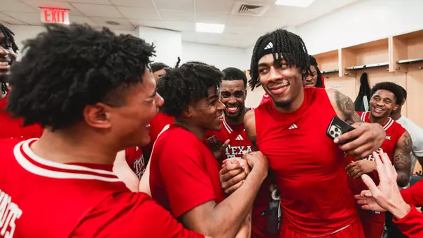 JT Toppin and Christian Anderson celebrate a win over Duke in a Madison Square Garden locker room after the game.