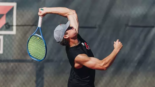 Ttyler Stewart hitting a serve.