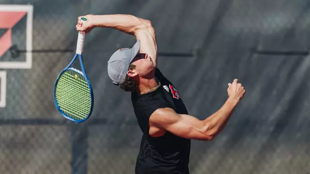 Ttyler Stewart hitting a serve.