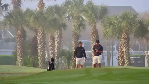 Adam Bresnu and head coach Greg Sands ponder Bresnu's next shot during the Hayt at Sawgrass Country Club