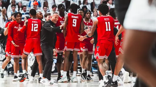 Grant McCasland and Jaylen Petty celebrate a nice play together during a timeout against BYU.