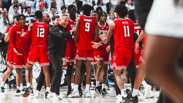 Grant McCasland and Jaylen Petty celebrate a nice play together during a timeout against BYU.