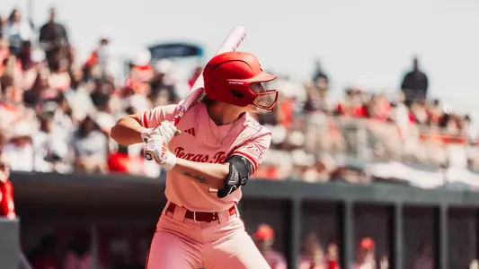 Jackie Lis stands ready in the batter's box as a pitch is about to be delivered.