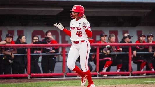 Mihyia Davis shrugs her shoulders as she approaches home plate after hitting a home run