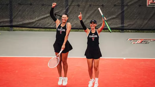 Hailey Murphy and Yekaterina Dmitrichenko celebrate after winning their doubles match.