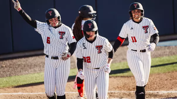 Taylor Pannell, Hailey Toney and Lauren Allred all returning to the dugout and celebrating after scoring a run