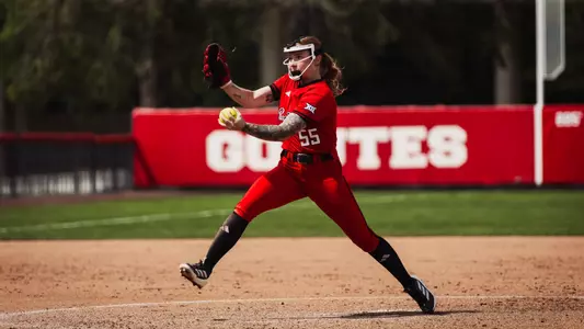 Kaitlyn Terry in her pitching motion against Utah while wearing all red jersey