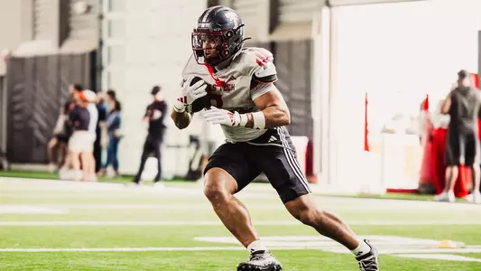 Running back Cameron Dickey running with the ball in practice