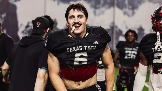 Linebacker John Curry staring at the camera while holding his mouthpiece