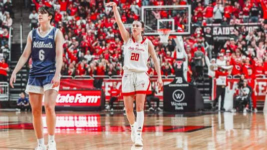 Bailey Maupin following through on a three point shot.