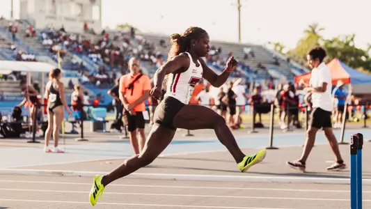 Lovina Ewusi getting ready to leap over the first hurdle in the 400 meters