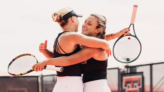 Elena Daskalova and Mariia Hlahola hug after winning their doubles match. Texas Tech vs Colorado women's tennis on March 28, 2026 in Lubbock, TX. (Photo by Gavin Daly/Texas Tech Athletics)