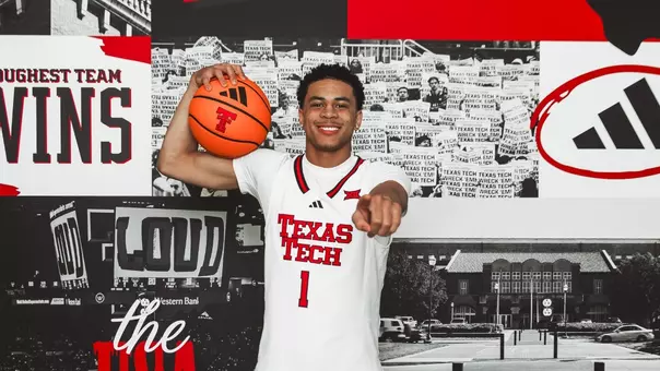 Damarion Dennis points to the camera and smiles during a recruiting visit at Texas Tech.