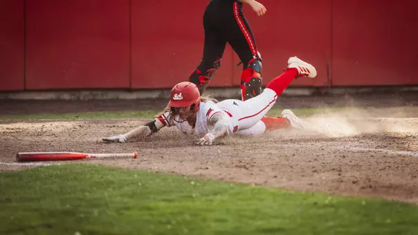 Kaitlyn Terry sliding home against Utah softball to score a run