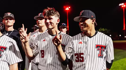 Connor Shouse and AJ Goytia flash the "Guns Up" following the Red Raiders Tuesday night win over Tarleton State