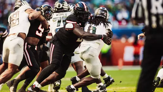 Lee Hunter wraps up an Oregon running back in the backfield during the Capital One Orange Bowl.