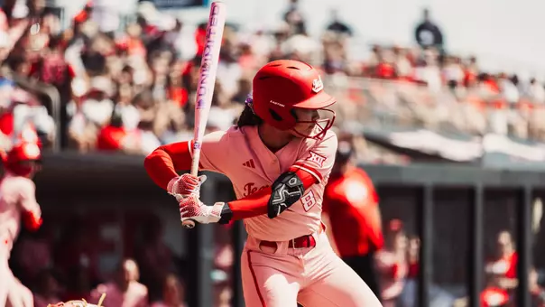 Desirae Spearman getting prepared to swing her bat in a softball game wearing all pink jersey