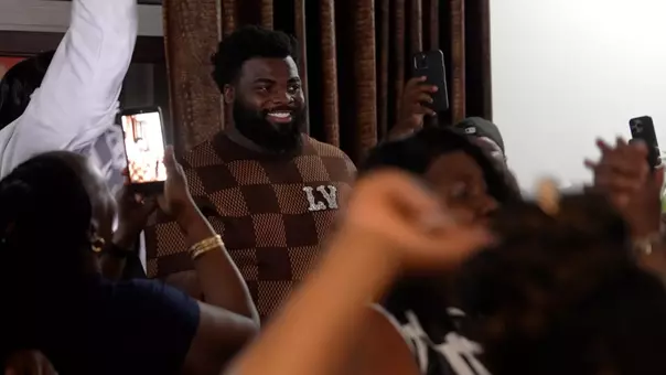 Lee Hunter reacts at home with friends and family after being selected by the Panthers.