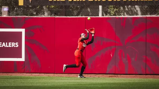 Makayla Garcia making a running catch in the outfield of a softball game against Arizona state
