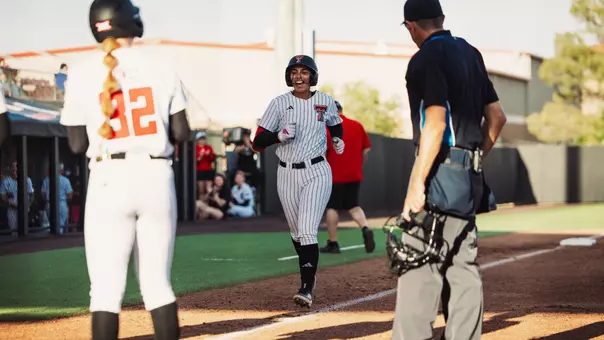 Lauren Allred cheers as she approaches home plate following a home run against Tarleton State