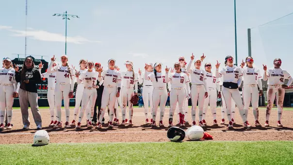 The texas tech softball team lining up to sing the schools alma mater after a game