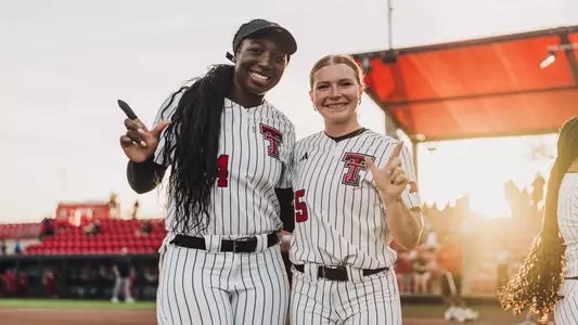 NiJaree Canady and Kaitlyn Terry celebrating after a win with the 'guns up' hand gesture