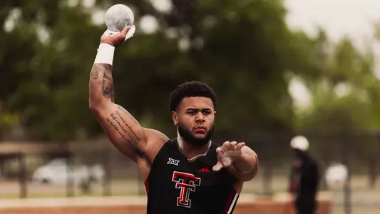 Trey Wilson holding the shot put