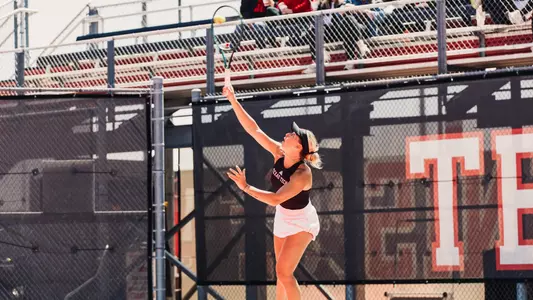 Mariia Hlahola serves the ball during the match.