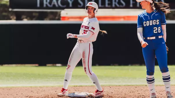 Hailey Toney standing on second base in an all white jersey with a BYU player looking back towards the outfield