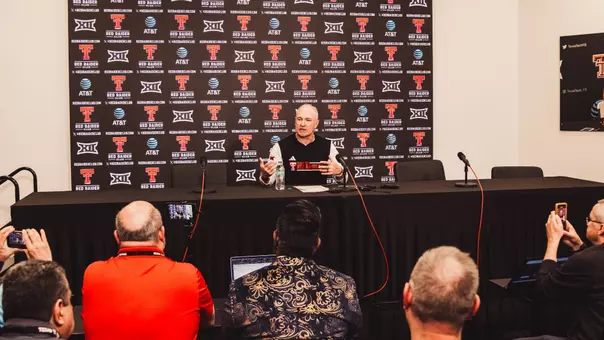Joey McGuire is pictured in Texas Tech's South End Zone Building press conference room, discussing the Red Raiders' win over BYU in 2025 with members of the media.