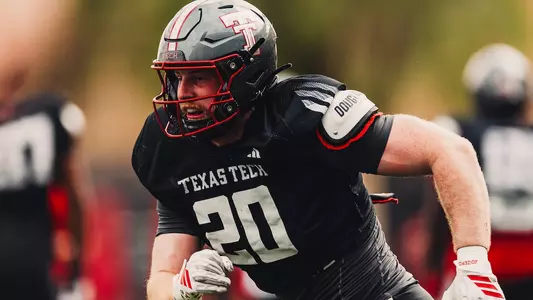 Adam Trick running a drill during spring practice