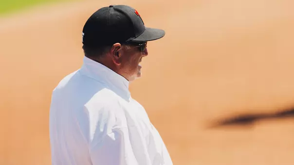 Gerry Glasco with a hat on coaching a softball game
