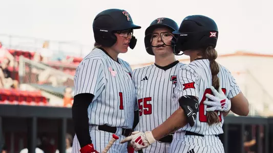 Kaitlyn Terry, Taylor Pannell and Jackie Lis celebrating at home plate after a home run