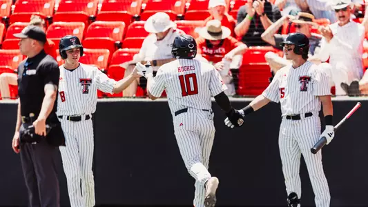 Logan Hughes is greeted by Caden Ferraro (Right) and Connor Shouse (Left) after hitting a home run