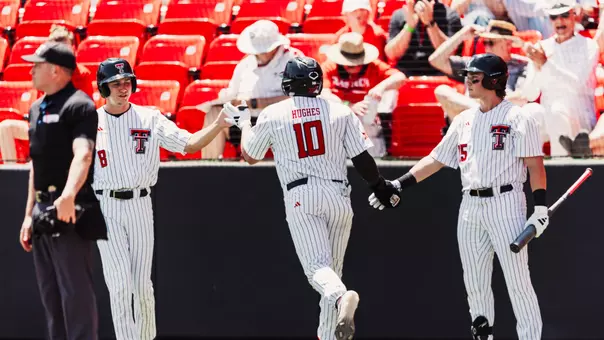 Logan Hughes is greeted by Caden Ferraro (Right) and Connor Shouse (Left) after hitting a home run