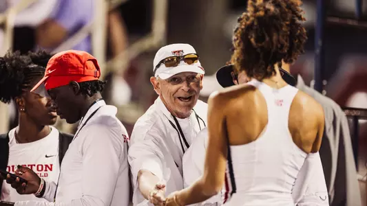 Head coach Wes Kittley congratulating Tamiah Washington after winning the triple jump
