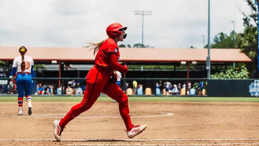 Mia Williams celebrating as she approaches first base after hitting a home run against Florida