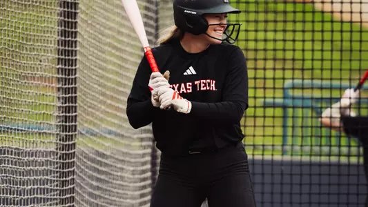 Taylor Pannell smiling while taking batting practice
