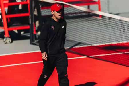 Head Men's Tennis Coach Michael Breler crosses through a court during the Red Raiders Contest vs. ORU