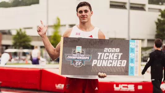 Jackson Bragg holding up an NCAA Ticket Punched sign