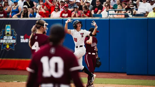 Jackie Lis celebrates after hitting a first-inning home run against Mississippi State in the Women's College World Series.