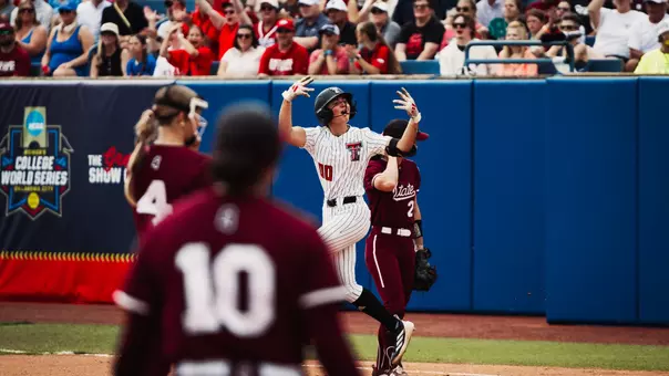 Jackie Lis celebrates after hitting a first-inning home run against Mississippi State in the Women's College World Series.