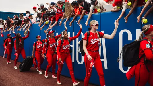 Texas Tech softball players greet fans before the start of a game at the Women's College World Series.