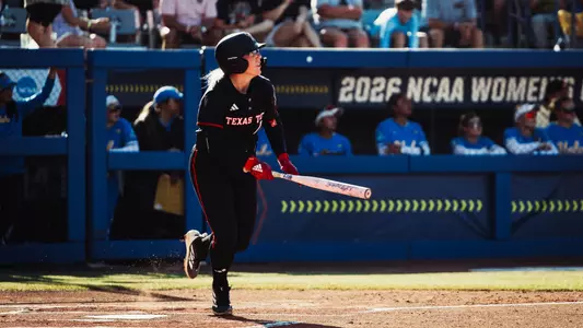 Mia Williams watches a hit smash of the center field wall for a single in the WCWS.